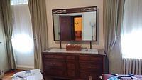 Front view showing dresser, nine drawers, attached mirror