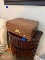 Closed wood chest atop stand