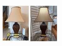 Full view of lamp on glass table showing base carving and shade