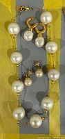 Full view of necklace with both earring pairs