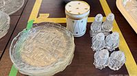 Overview of porcelain canister, plate, six shakers and portion of textured glassware