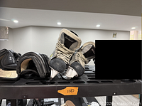 Pair of Graf skates and Itech gloves on rack