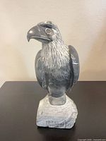 Front view of signed soapstone eagle sculpture on base