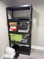 Front view of black 5-shelf plastic unit with items illustrating shelf count and style