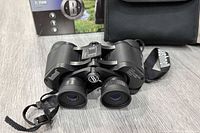 Binoculars with strap, case and box visible