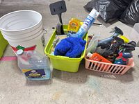 Overall lot with bucket, cleaners, towels, brushes visible