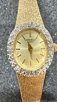 Front view showing gold dial, rhinestone bezel and Caravelle branding