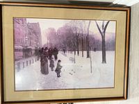 Front view of framed winter city landscape print with mat and gold-bronze wood frame