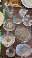 Group overview of all eight glass pieces on table