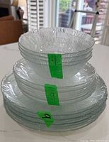 Stack showing bowls, salad plates, dinner plates with green count tags