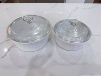 Both casserole dishes side-by-side with lids on