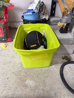 Knee pads visible in green tote