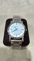 Front view of DKNY wristwatch on cushion showcasing dial and case