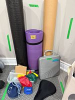 Group view of mats, foam roller, hard case, bands, weights, bags