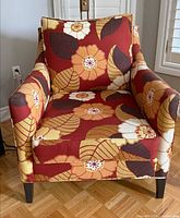 Front view of floral red/rust armchair