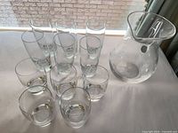 Group shot of pitcher and 11 glasses on table