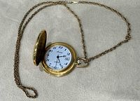 Open hunter-case Amee pocket watch showing dial and chain