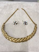 Necklace and earrings laid out for full view