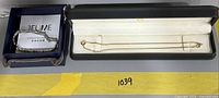Overall lot showing bracelet in JFUME box and necklace in presentation box