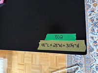 Tape on desktop showing measurements 48 x 28 x 31.25 inches