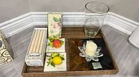 Overall view of vase, tiles, candles, lotus holder, napkins, tray