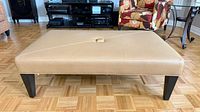 Front view of rectangular ottoman showing full shape and legs