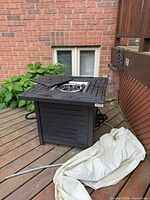 Full view of fire pit on deck showing overall structure and hose