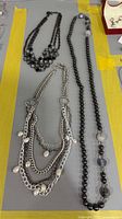 Overall view of three necklaces on surface