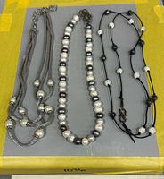 All three necklaces laid flat showing full designs