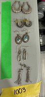 All five earring pairs laid out vertically on table