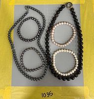 Overview of two bead necklaces and four bracelets