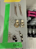 Overview of all six earring pairs laid out on tray