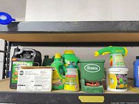Overview of assorted lawn care products and Scotts hand spreader on shelf