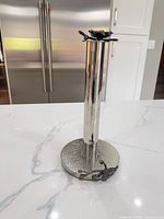 Full view of chrome paper towel holder on countertop