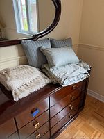 All bedding items stacked on dresser