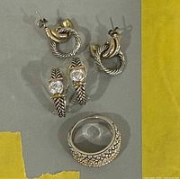 Lot overview showing both earring pairs and ring