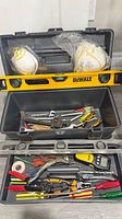 Overall view of toolbox, DeWalt level, respirator masks and mixed hand tools