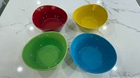 Four colored bowls arranged on countertop