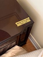 Top corner of nightstand showing veneer surface and finish