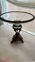 Top view of crystal compote showing etched glass dish and brass rim