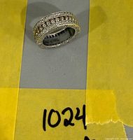 Full view of ring on yellow paper showing entire band design