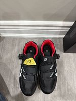 Top view of both Peloton shoes showing buckle, Velcro straps, red lining