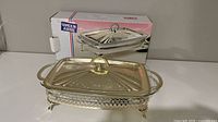 Casserole on stand with lid, box in background