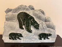 Front view showing entire grey stone slab with green marble inlay bears