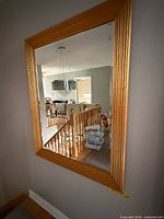 Full view of rectangular gold wood frame wall mirror
