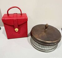 Jewelry box closed beside glass jar with lid