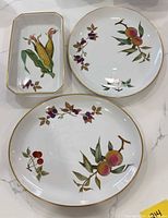 Rectangular relish tray, dinner plate, deep serving bowl showing motifs and gold trim