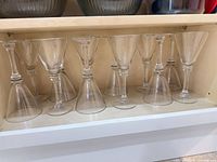 All 12 glasses inverted on shelf showing quantity and foot design.