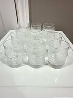 Front view of 12 clear textured tumblers arranged together