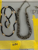 Both necklaces laid flat showing overall design and clasps